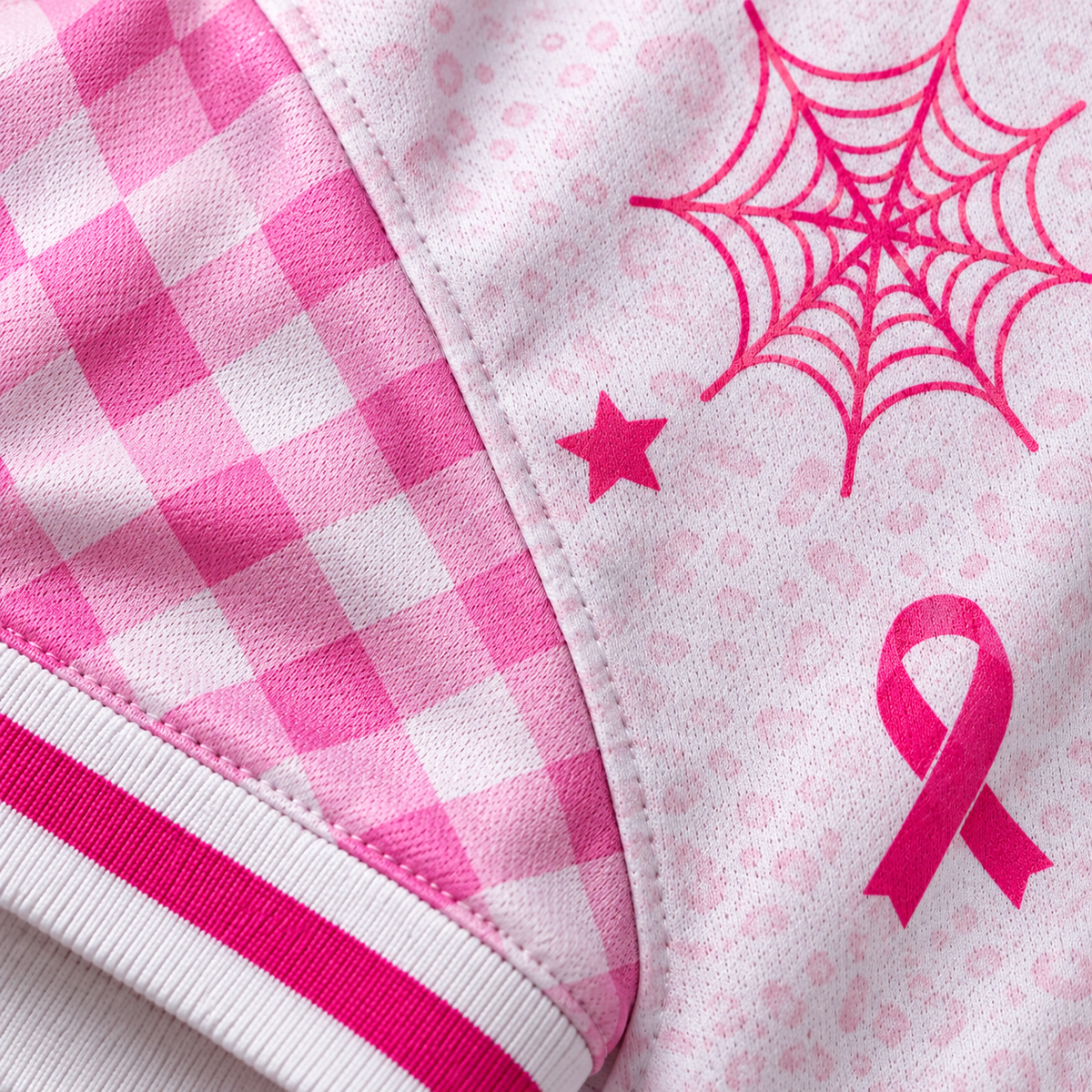 Close-up of pink gingham sleeve and printed pink ribbon fabric