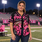 Woman wearing the pink out awareness jersey on a football sideline at night