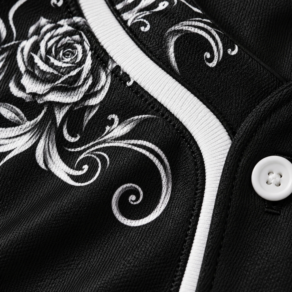 Close-up of the white baroque filigree print on the black jersey fabric