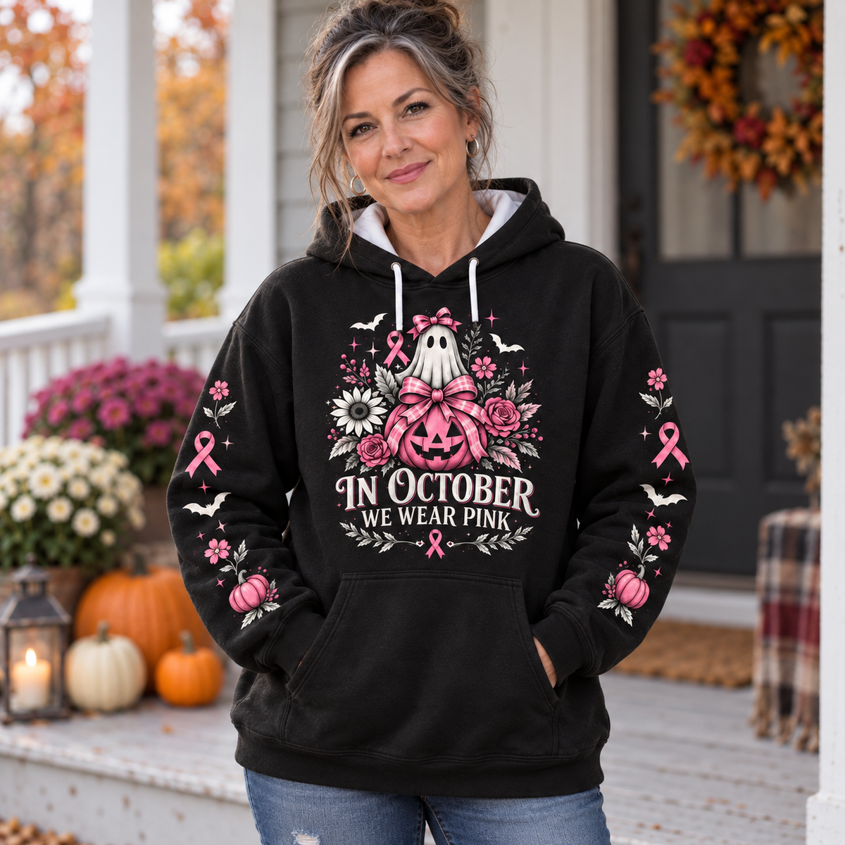 Woman wearing the vintage floral pink awareness hoodie on an autumn porch