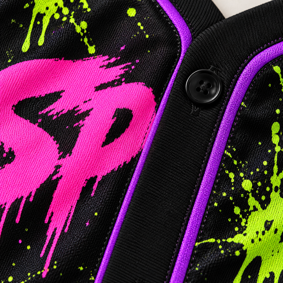 Close-up of the neon pink and green print on the black polyester jersey fabric