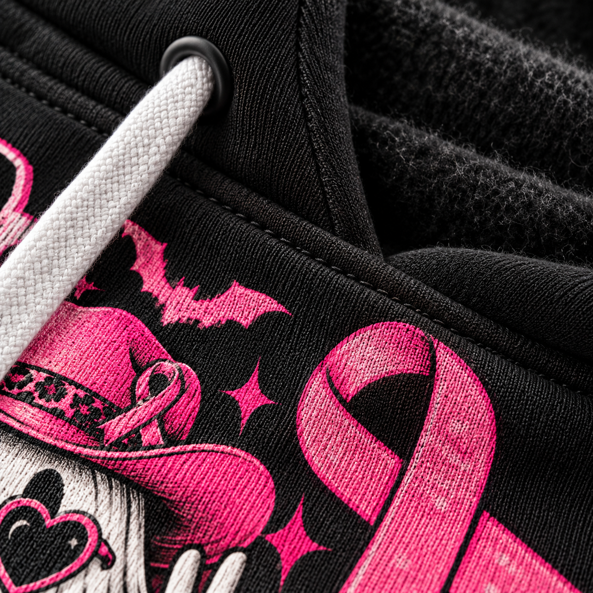 Close-up of the hot pink ribbon print on the black brushed fleece fabric