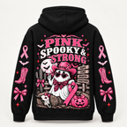 Back view reading Pink Spooky and Strong with a cowgirl ghost, hay bales and a Hope Cure Braver Together signpost