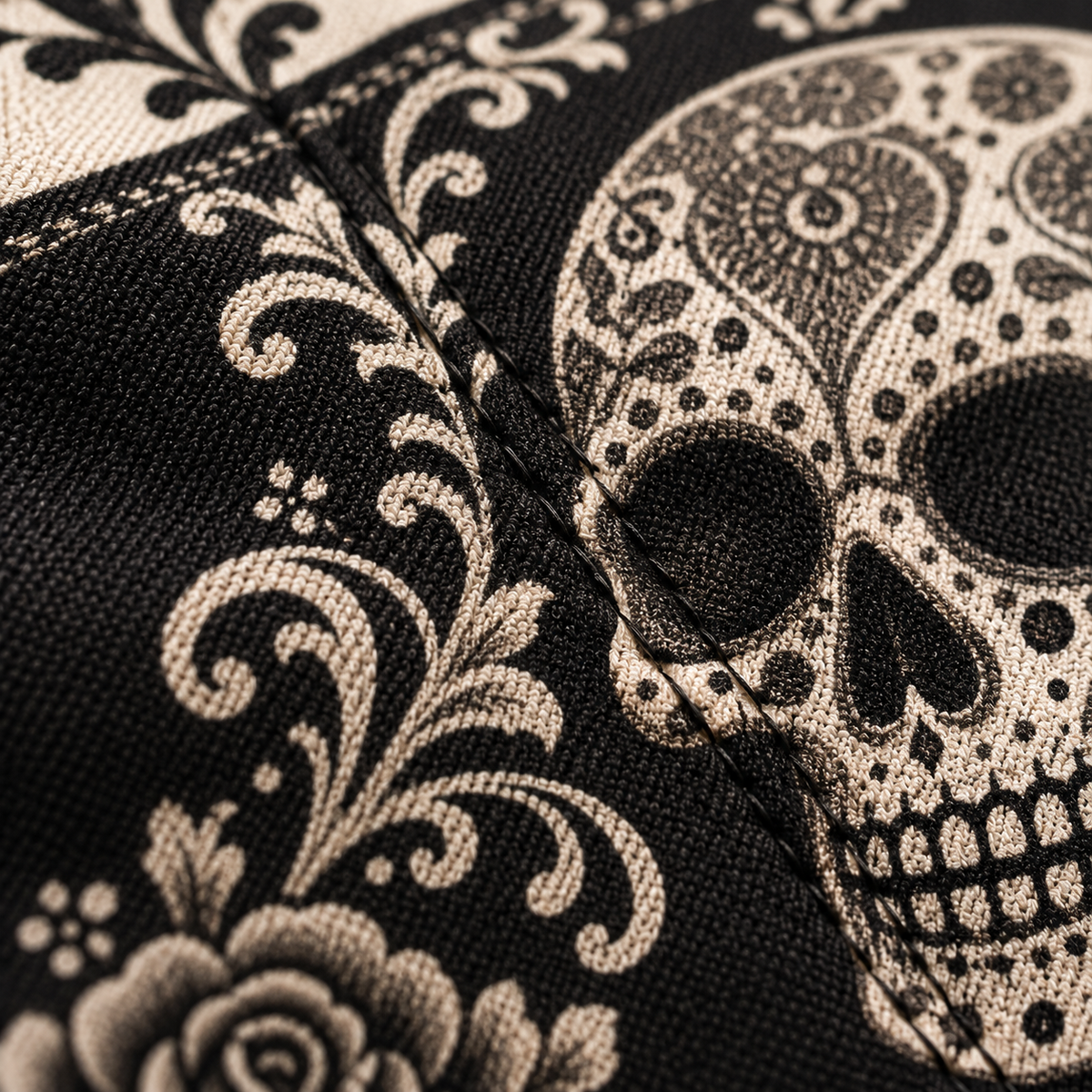 Close-up of the sugar skull print across a seam, showing the weave of the fabric