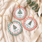 Three personalized round ceramic Christmas ornaments with hand-drawn trees, names and 2026